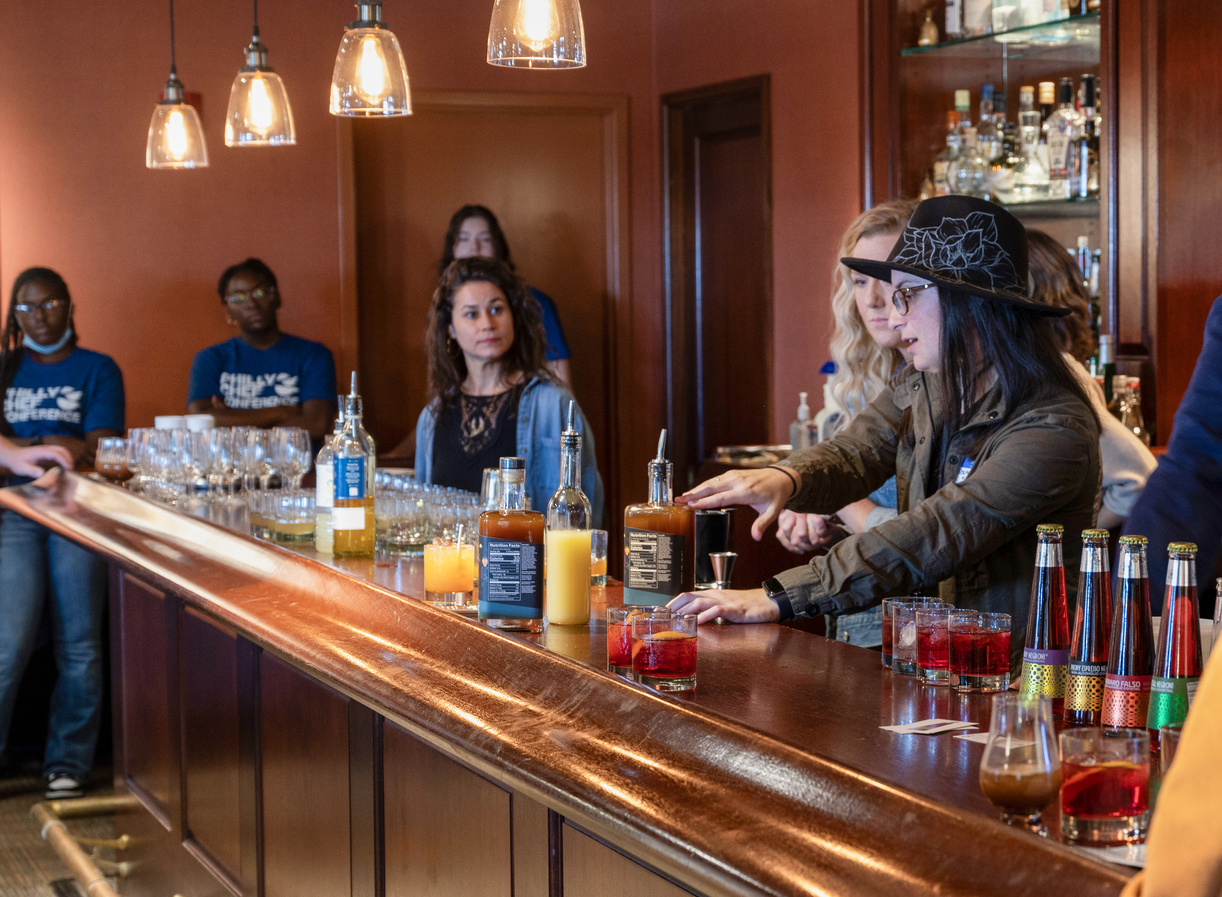Woman does mixology demonstration at a bar